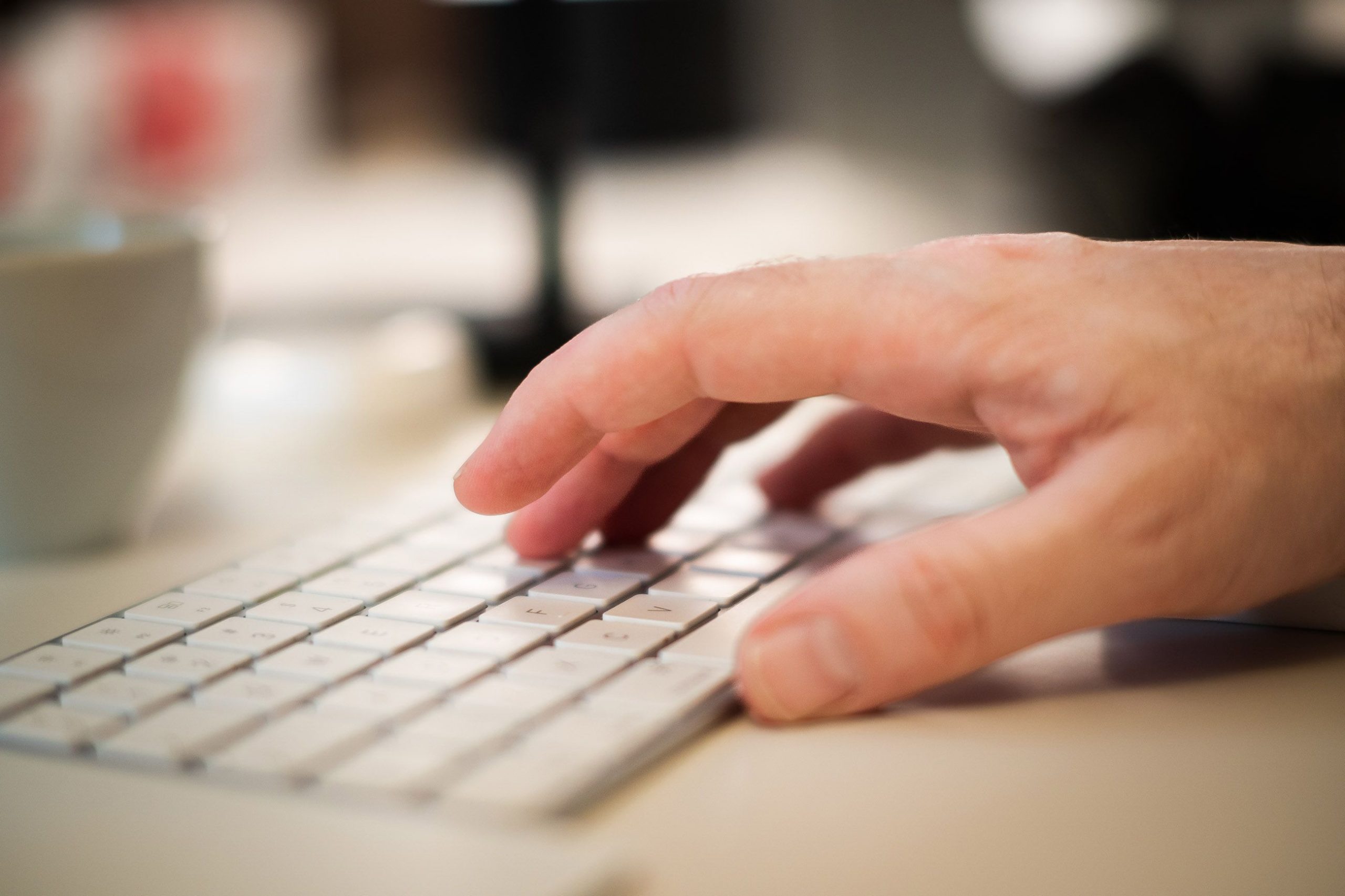 man's hand hovering over a key board